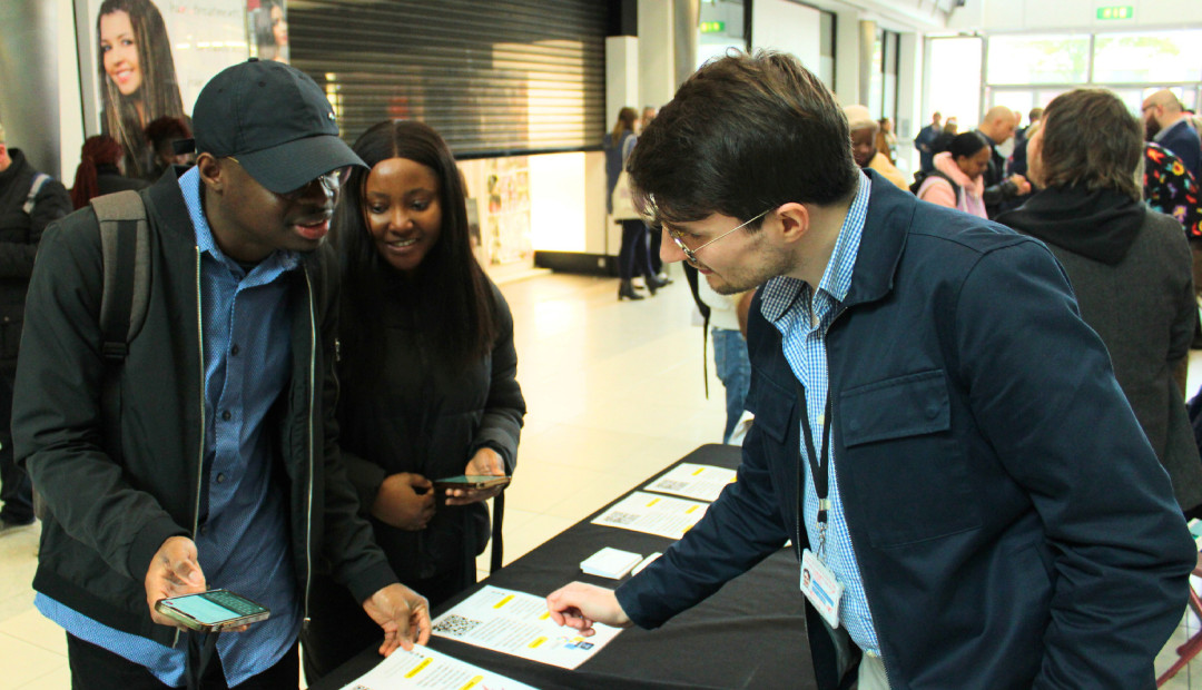 Into Work Advice Service's Cardiff Works Manager with event attendees [photograph]